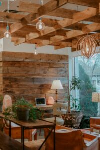 Office Space with warm wood, plants, and orange chairs